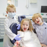 three kids at the dental office