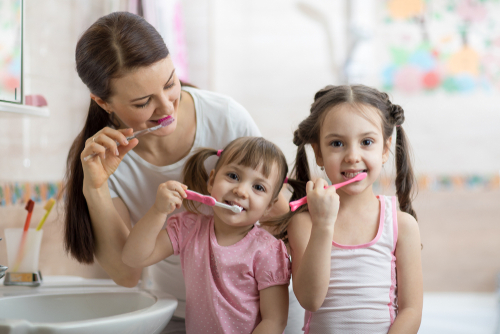 family brushing teeth